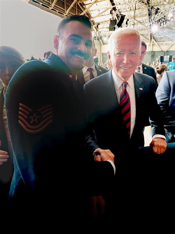 U.S. Air Force Technical Sgt. Cristopher Williams, left, with President Joe Biden
